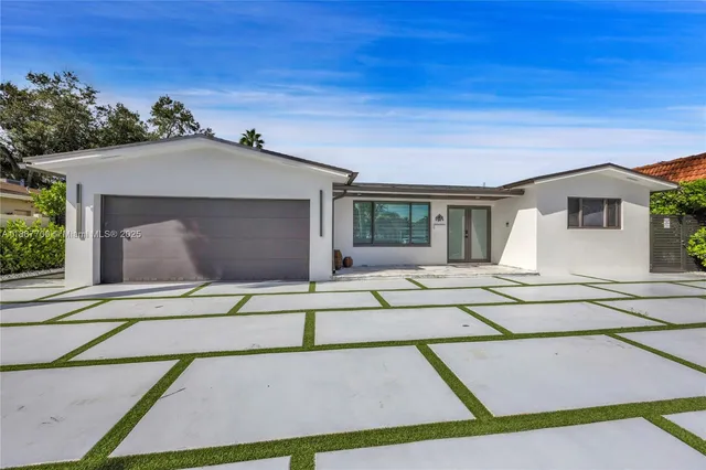 a front view of a house with garage