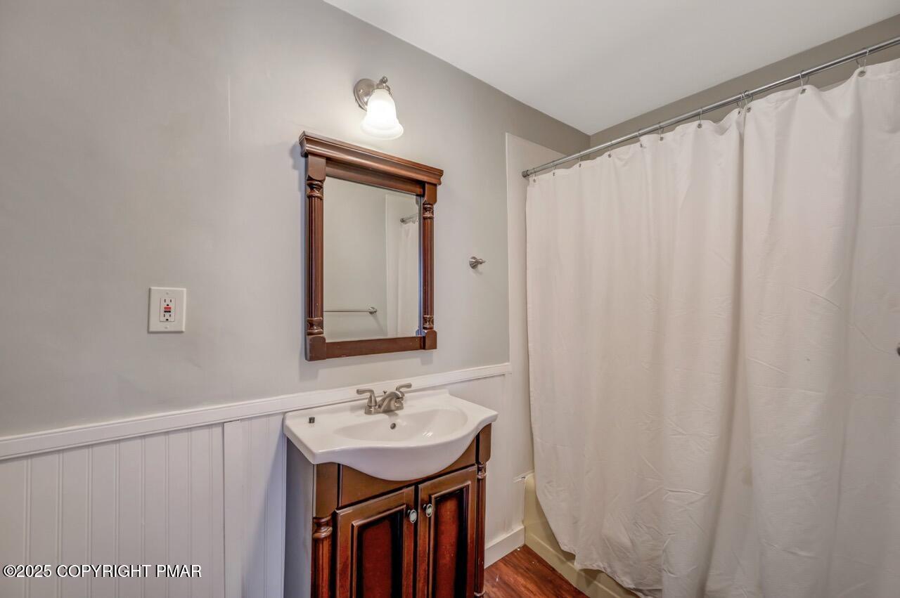 3 Stone Tree Drive Canadensis, PA 18325 - Photo 120 of 201 a bathroom with a sink a mirror and a shower curtain