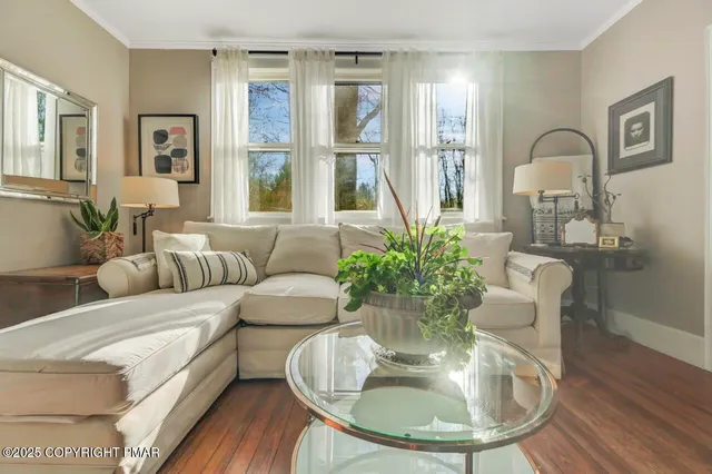 a front view of a house with a yard table and chairs