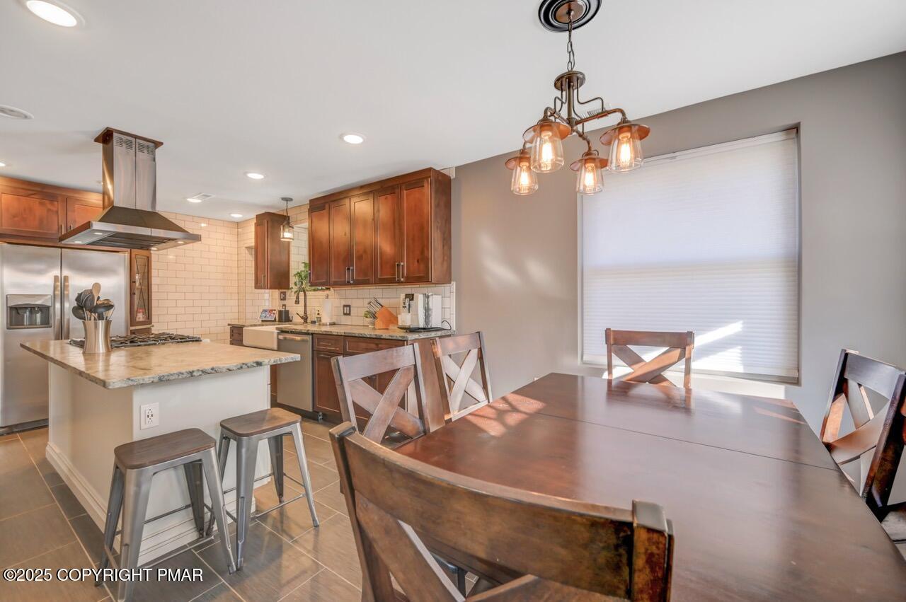 3 Stone Tree Drive Canadensis, PA 18325 - Photo 152 of 201 a kitchen with stainless steel appliances kitchen island granite countertop a table chairs in it and wooden floors