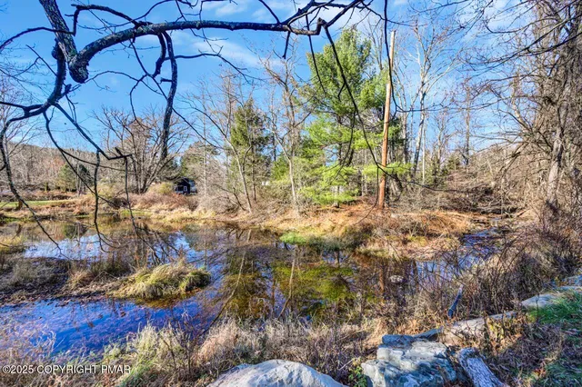 a living room with furniture a flat screen tv and a large window
