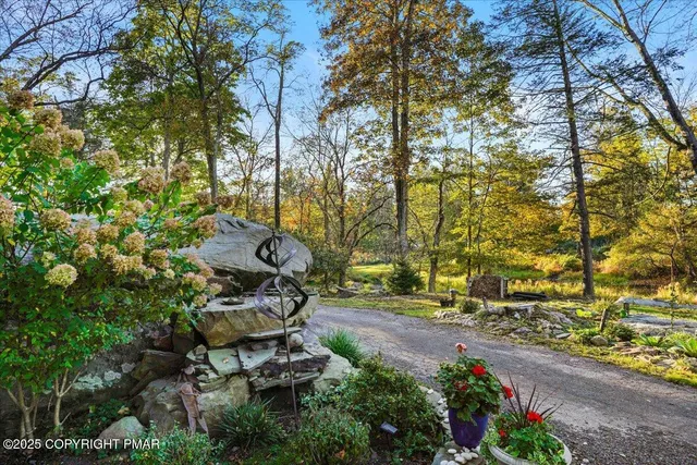 a front view of a house with a garden and yard