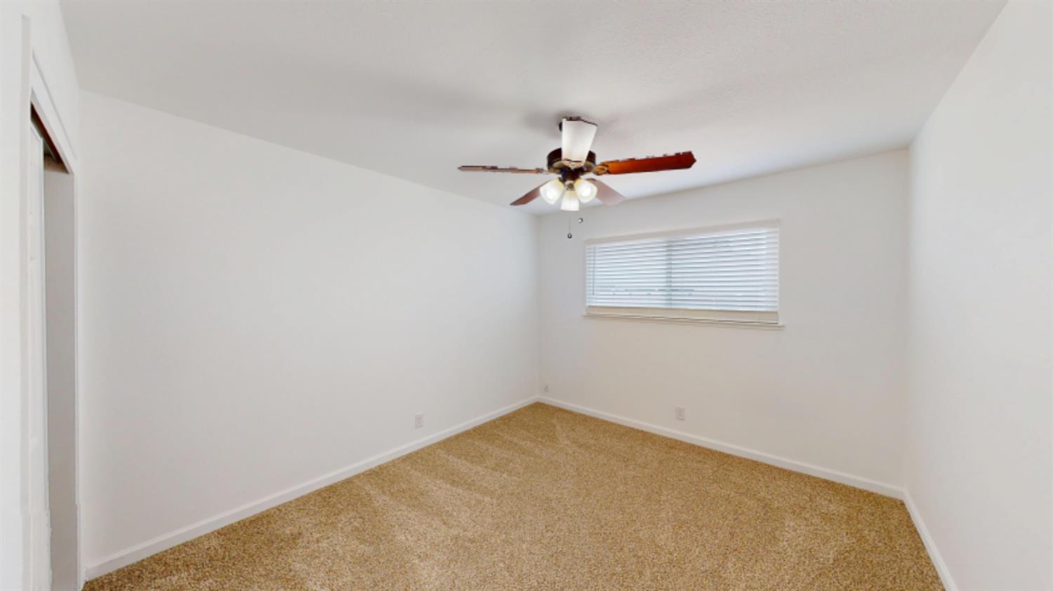3279 Cherokee Avenue Merced, CA 95340 - Photo 17 of 30 an empty room with a window and a fan