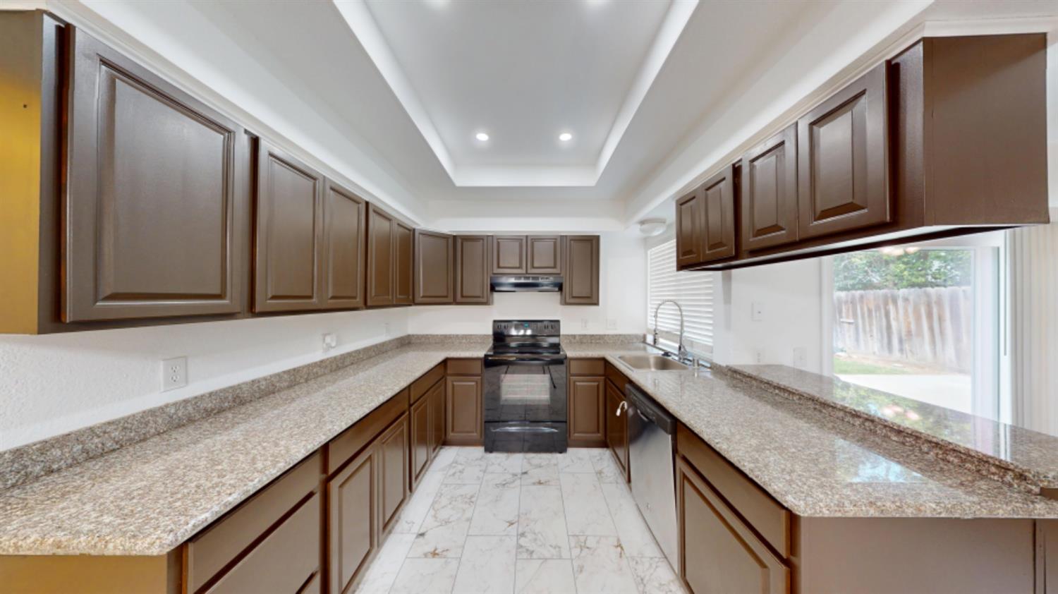 3279 Cherokee Avenue Merced, CA 95340 - Photo 4 of 30 a kitchen with stainless steel appliances granite countertop a sink stove and refrigerator