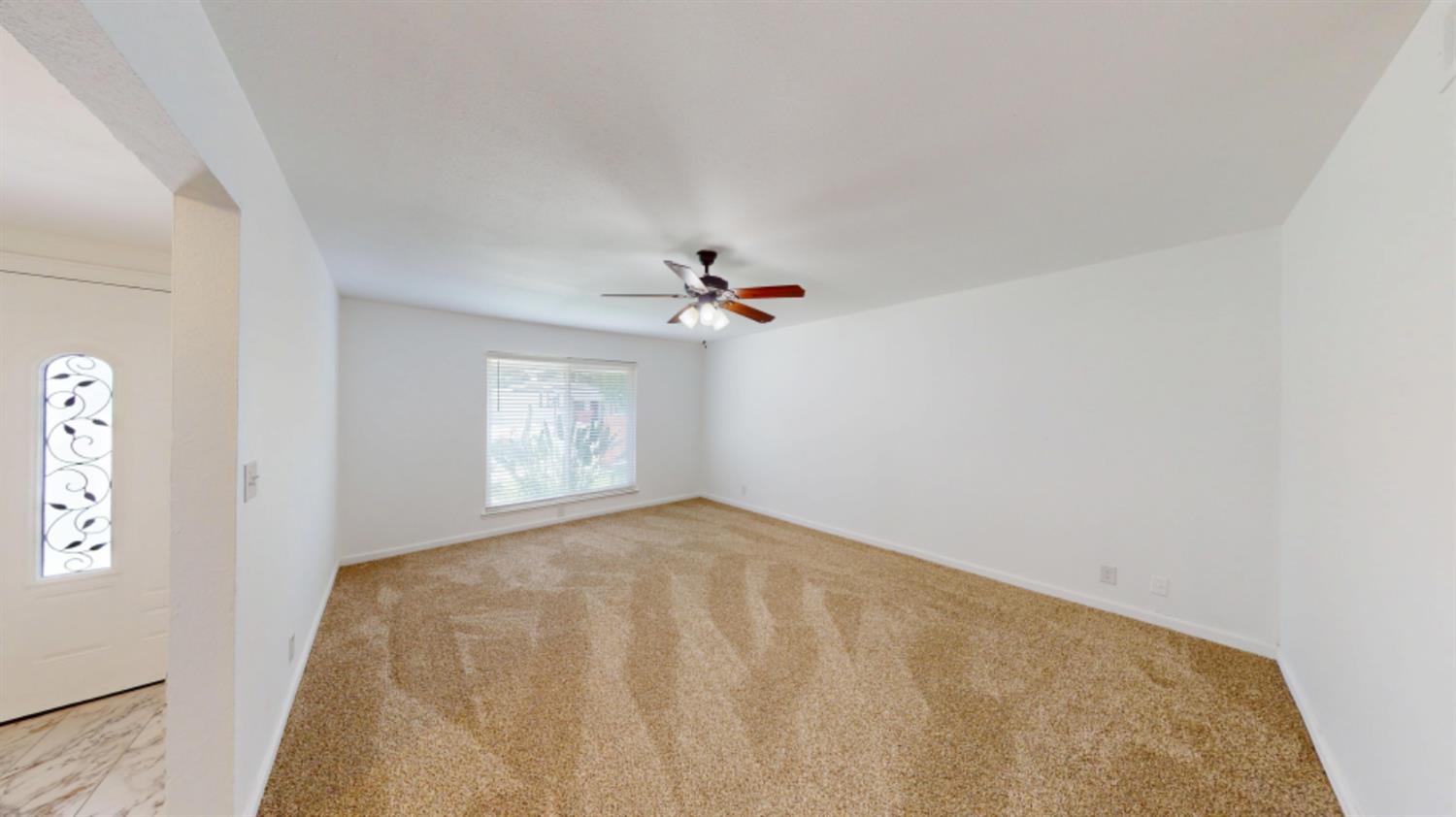 3279 Cherokee Avenue Merced, CA 95340 - Photo 7 of 30 a view of a big room with windows and chandelier fan