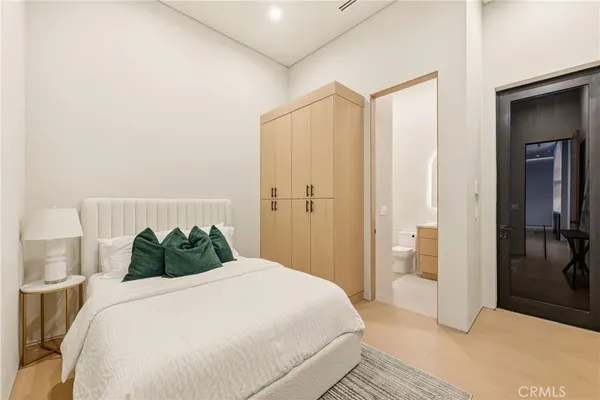 a bathroom with a toilet sink a mirror and shower