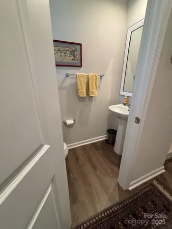 view of a room with wooden floor and staircase
