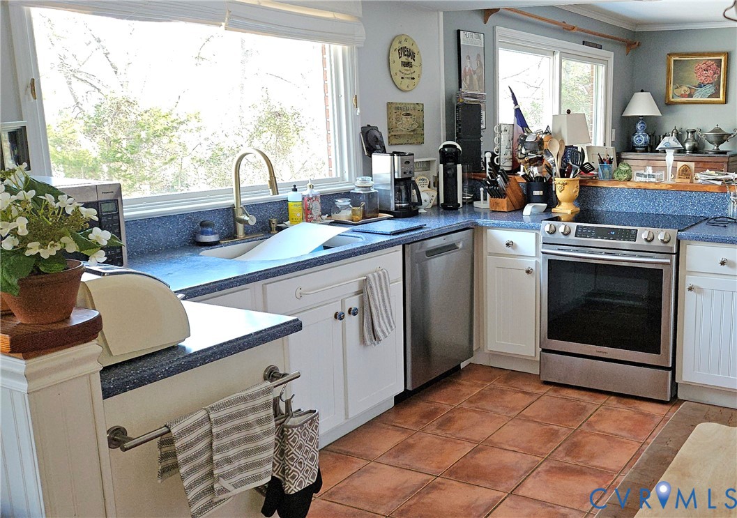 459 Willow Lane Topping, VA 23169 - Photo 14 of 47 a kitchen with a sink stove and cabinets