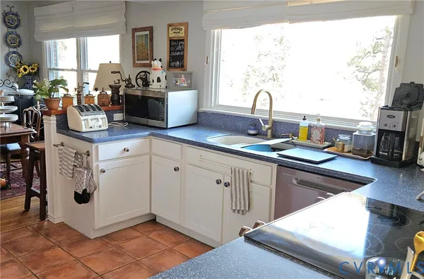 a kitchen with white cabinets and white appliances