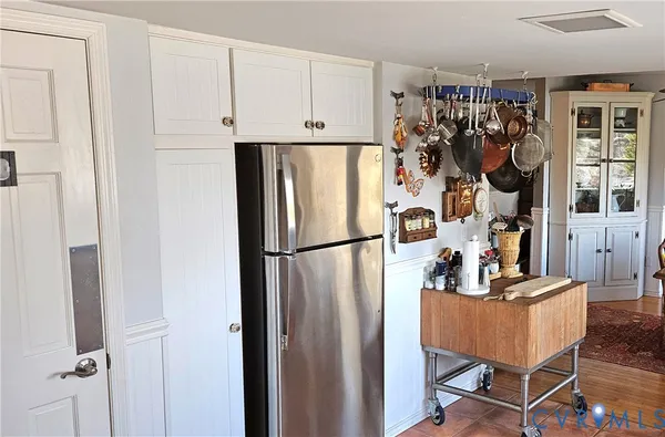 a dining room with furniture a large window and a chandelier