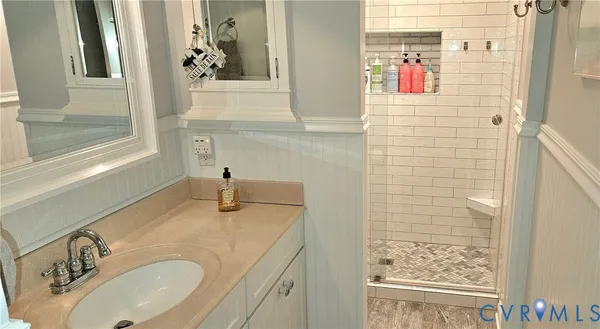 a view of entryway with wooden floor and cabinet