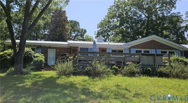 a front view of house with a garden