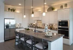a kitchen with a table and chairs in it