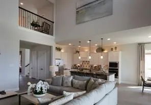 a living room with furniture and a view of kitchen
