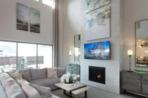 a living room with furniture a fireplace and a large window