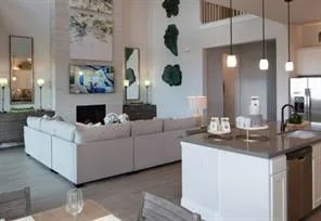 a living room with furniture and a chandelier