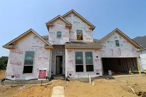 a view of a white house with large windows and a small yard