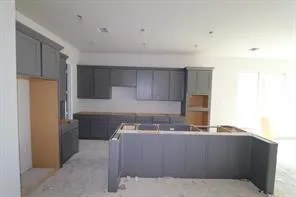 a room with a sink cabinets and refrigerator