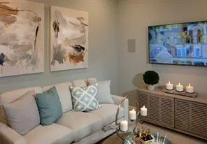 a living room with furniture and painting on the wall