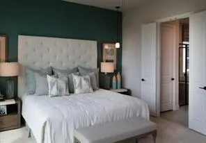 a bedroom with a bed and a night stand