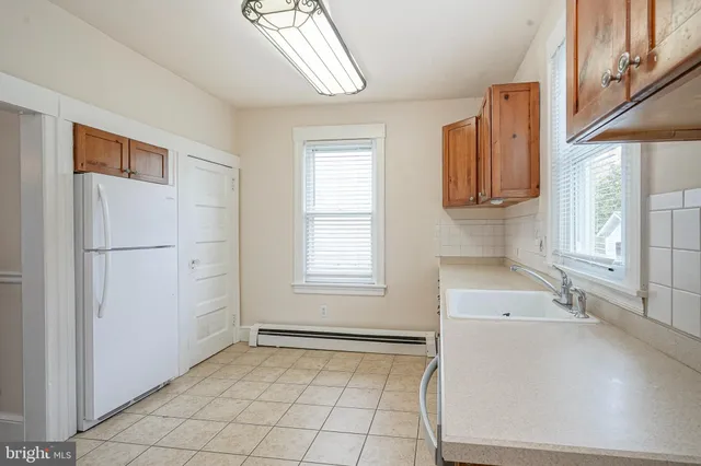 a view of a kitchen with a sink dishwasher and a microwave oven