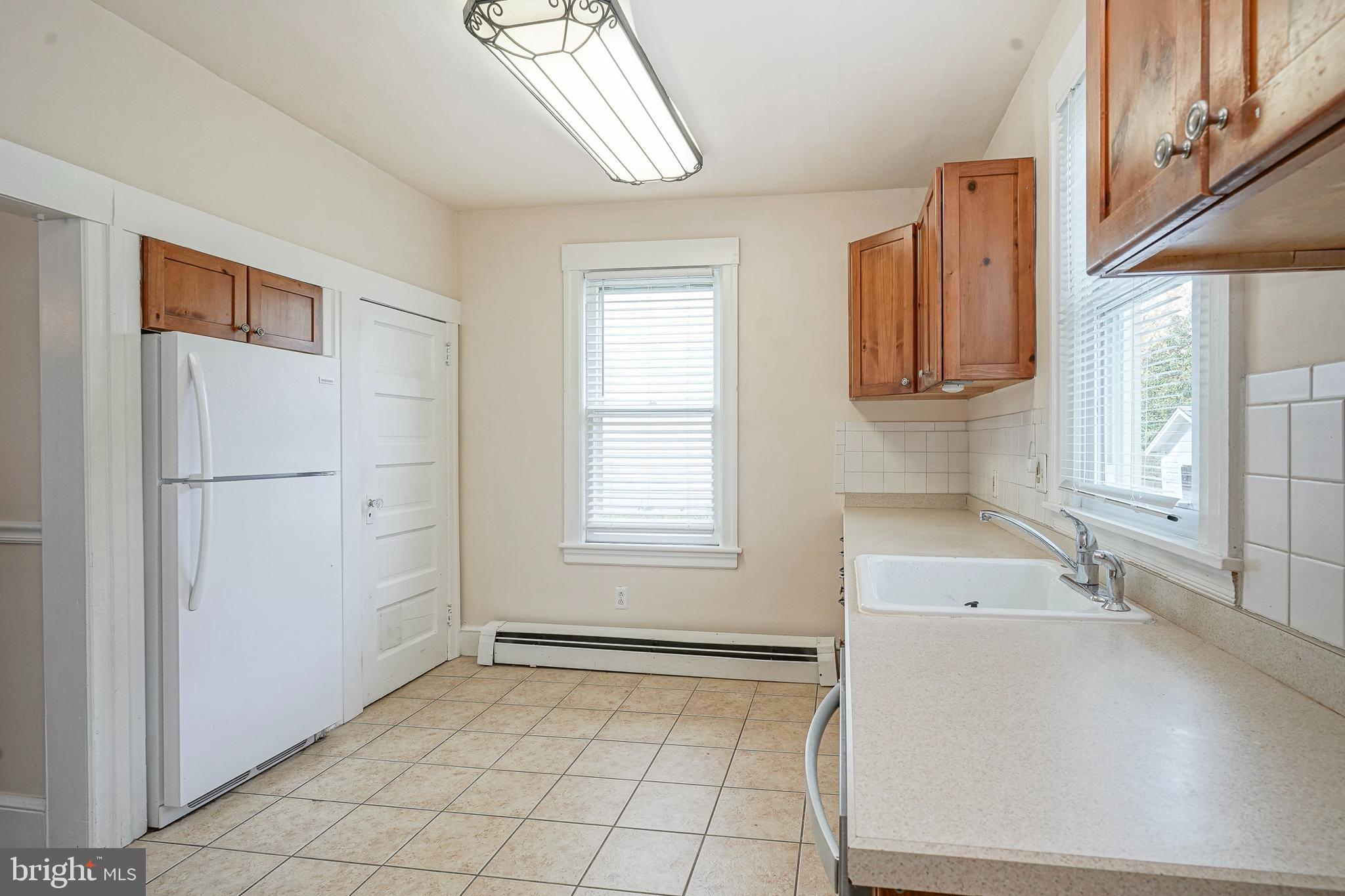 107 Colonial Avenue Haddonfield, NJ 08033 - Photo 12 of 29 a view of a kitchen with a sink dishwasher and a microwave oven