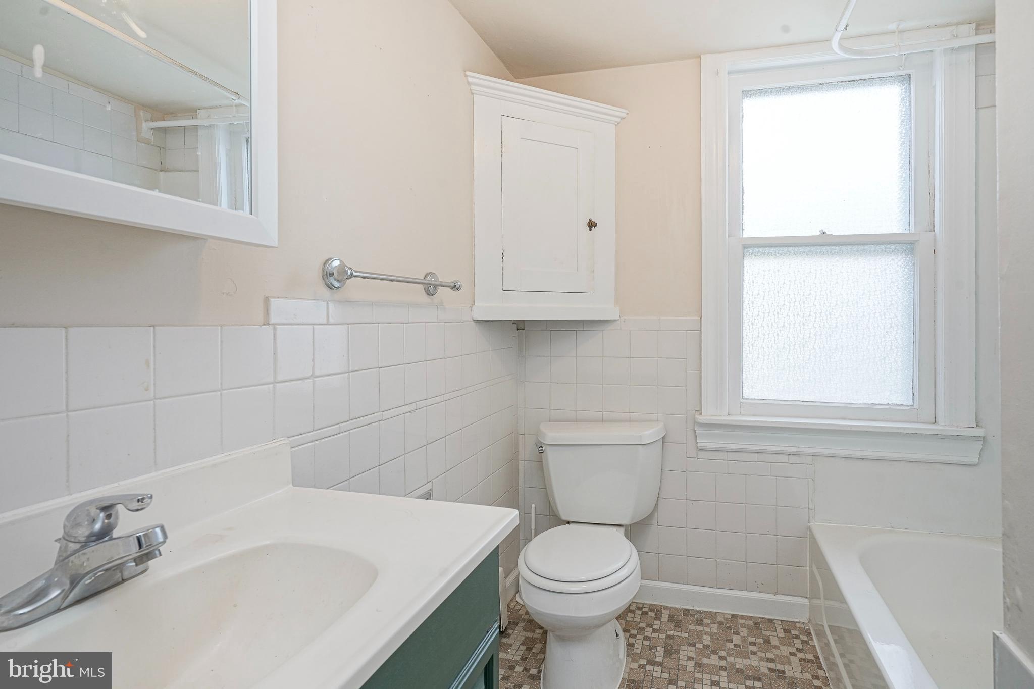 107 Colonial Avenue Haddonfield, NJ 08033 - Photo 15 of 29 a bathroom with a sink a toilet and a window