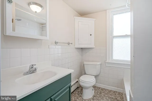 a bathroom with a sink toilet and vanity