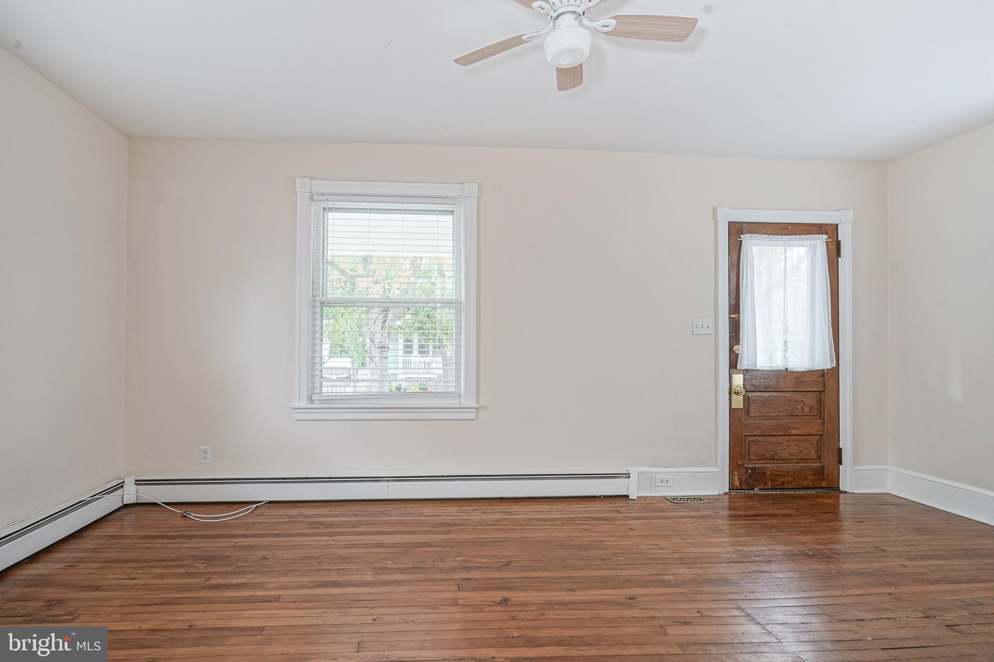 107 Colonial Avenue Haddonfield, NJ 08033 - Photo 5 of 29 a view of an empty room with wooden floor and a window
