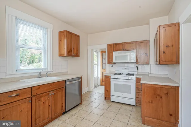 a kitchen with a stove sink and cabinets