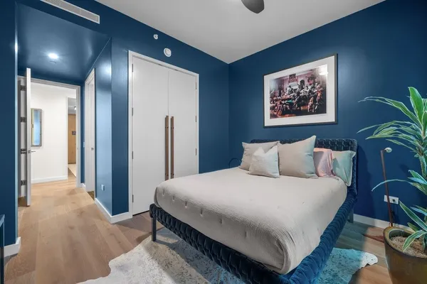 a bedroom with bed and a chandelier