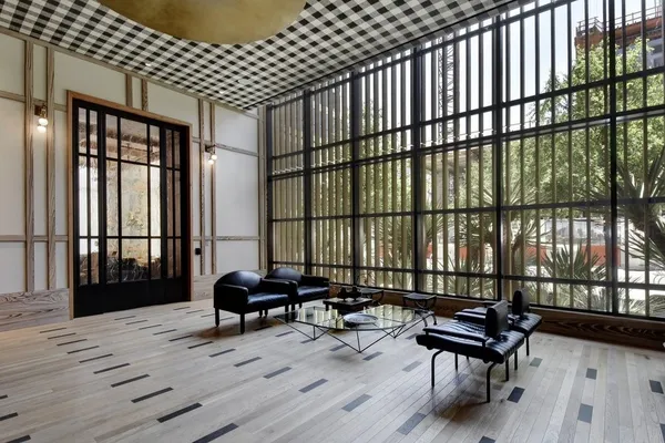 a living room with furniture and a floor to ceiling window