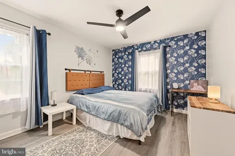 a bedroom with a bed and a painting on the wall