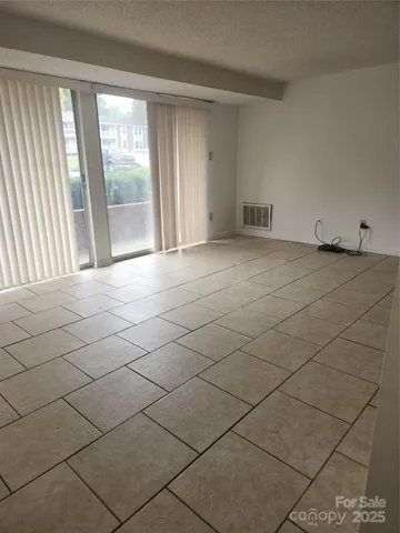 a view of an empty room and a window