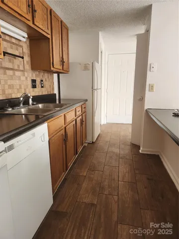 a kitchen with stainless steel appliances a sink stove and cabinets