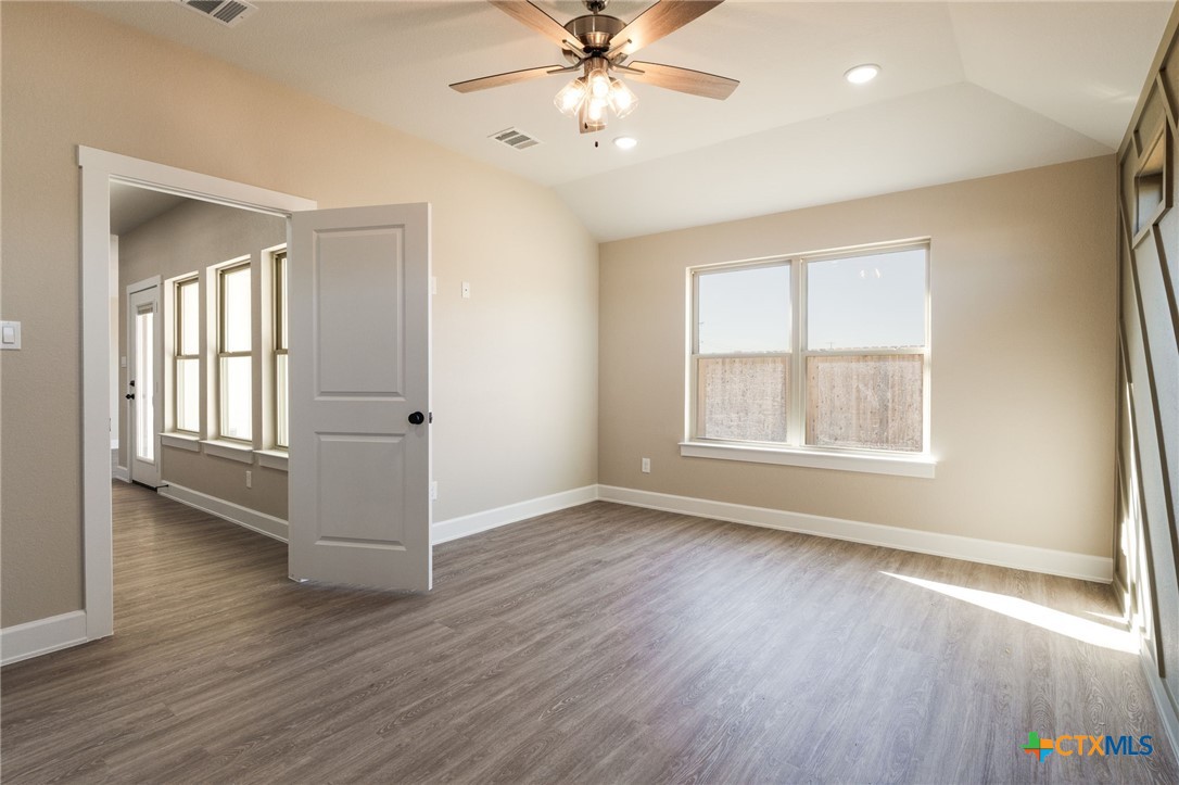 2005 Blackhawk Loop Belton, TX 76513 - Photo 15 of 37 an empty room with wooden floor chandelier and windows