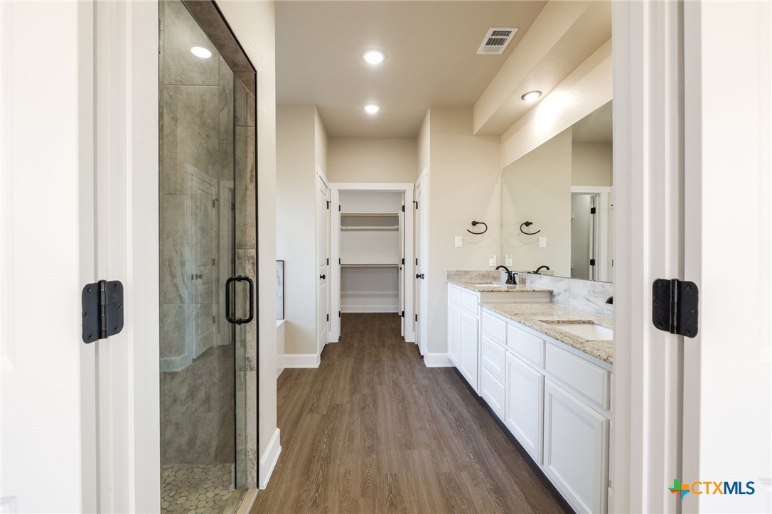 2005 Blackhawk Loop Belton, TX 76513 - Photo 19 of 37 a large bathroom with a glass shower door a sink and a mirror