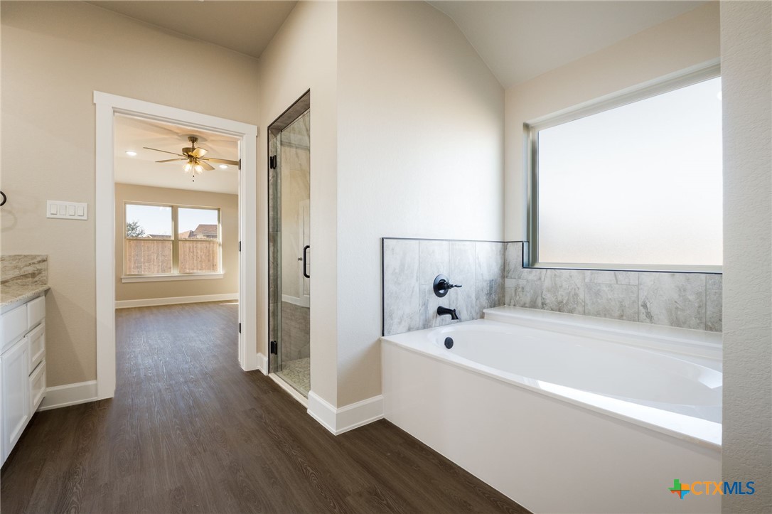 2005 Blackhawk Loop Belton, TX 76513 - Photo 21 of 37 a white bath tub sitting next to a bathroom sink