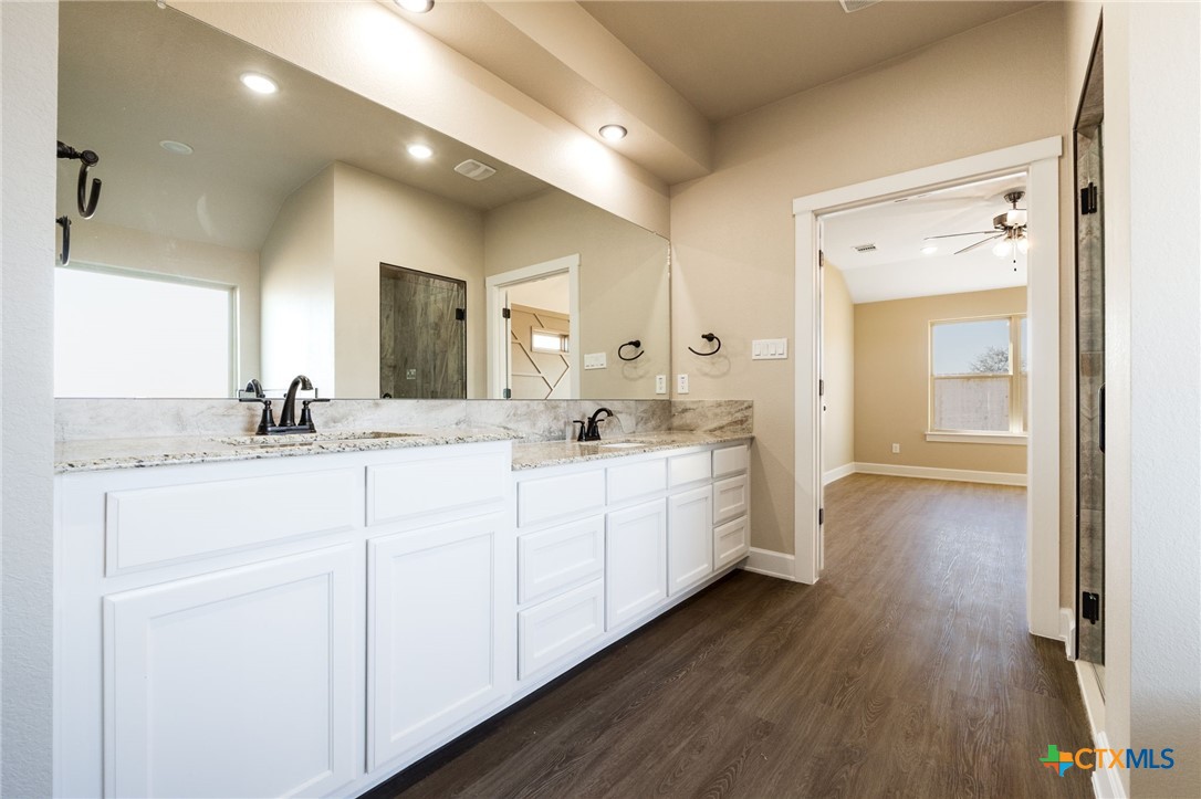 2005 Blackhawk Loop Belton, TX 76513 - Photo 22 of 37 a bathroom with a double vanity sink and a mirror