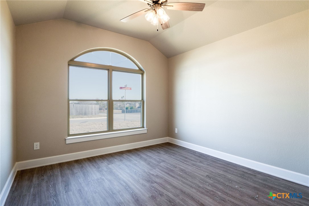 2005 Blackhawk Loop Belton, TX 76513 - Photo 27 of 37 an empty room with wooden floor chandelier and window