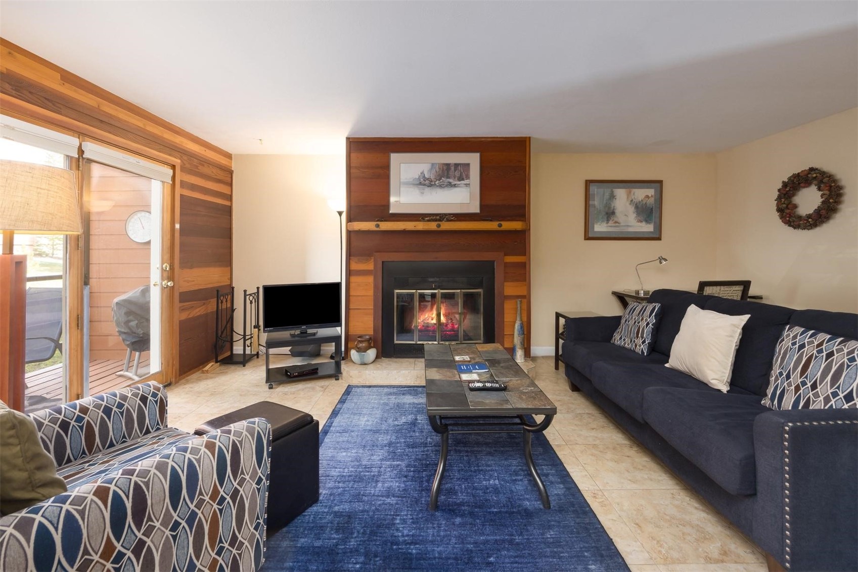 91100 Ryan Gulch Road, Unit 91105 Silverthorne, CO 80498 - Photo 4 of 49 a living room with furniture large window and a fireplace