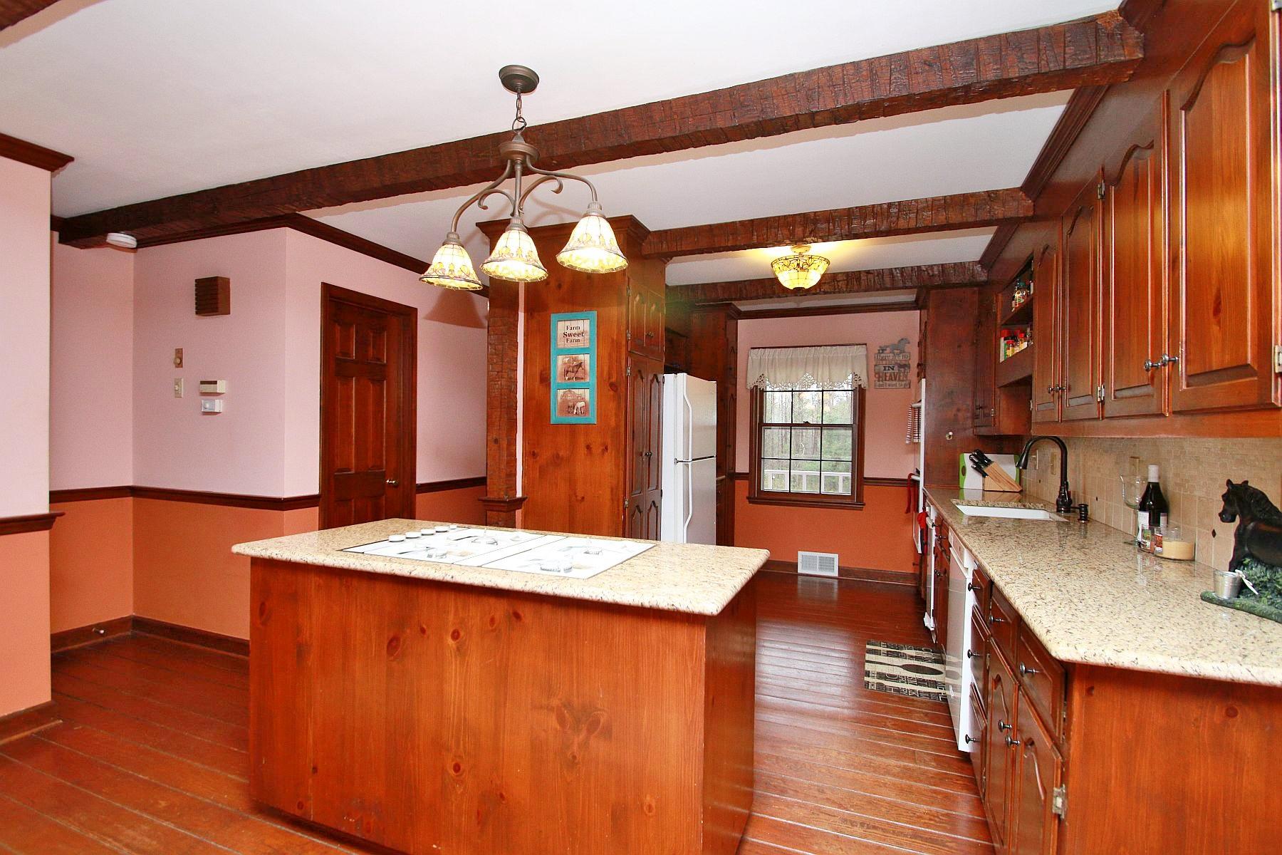 392 Morgans Fork Road Penhook, VA 24137 - Photo 11 of 56 a kitchen with stainless steel appliances granite countertop a sink dishwasher and a stove with wooden floor