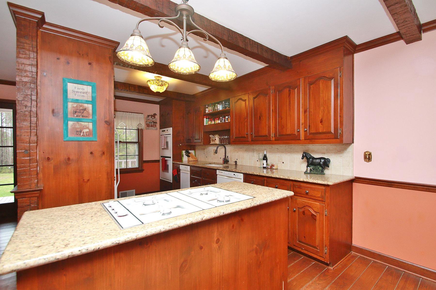 392 Morgans Fork Road Penhook, VA 24137 - Photo 12 of 56 a kitchen with stainless steel appliances kitchen island granite countertop a sink a stove and cabinets
