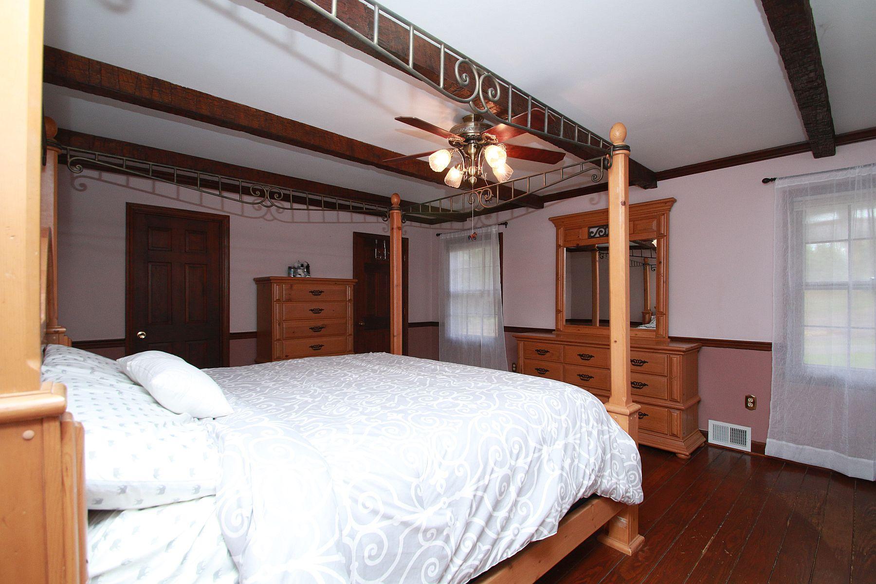 392 Morgans Fork Road Penhook, VA 24137 - Photo 16 of 56 a bedroom with a bed and a dresser