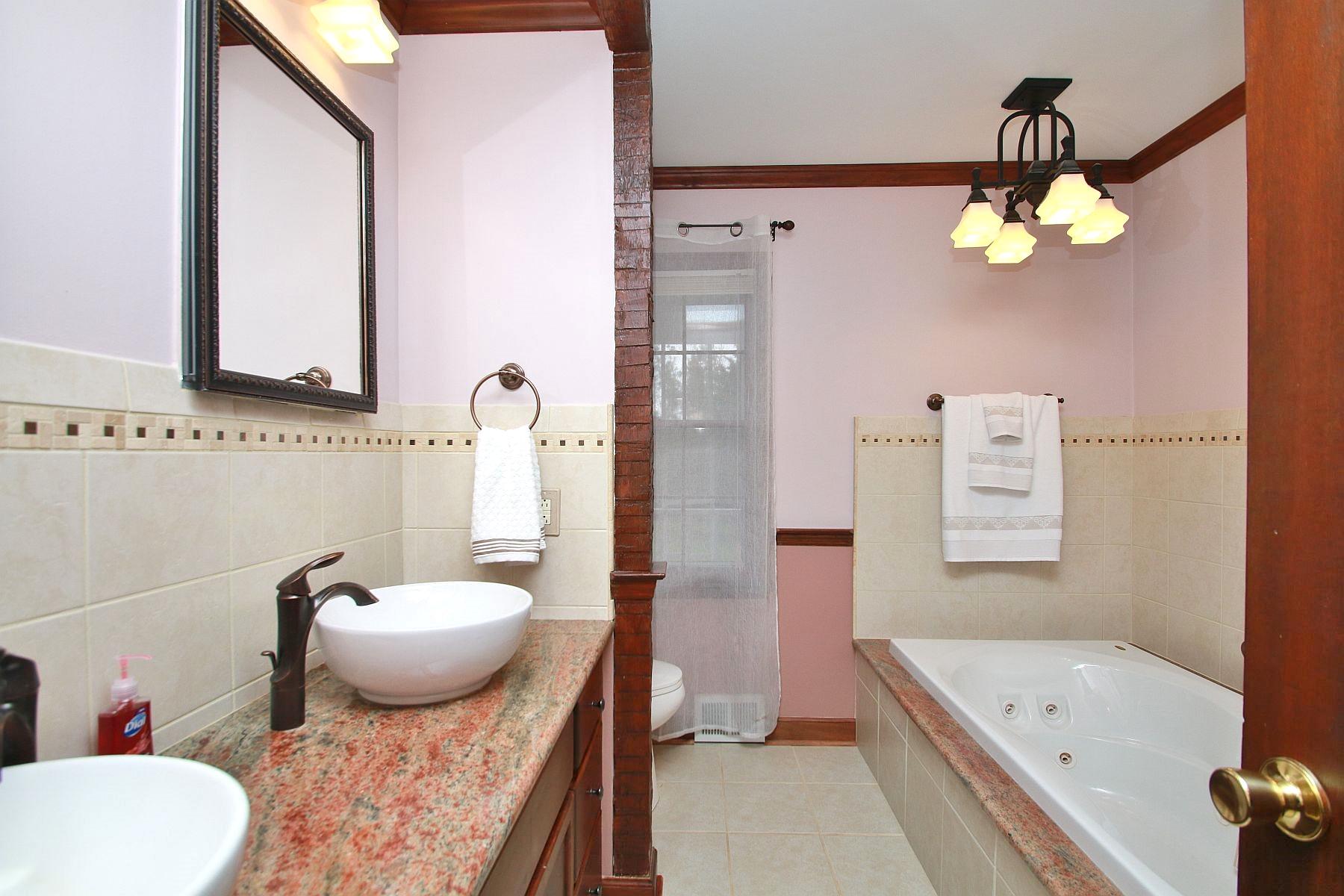 392 Morgans Fork Road Penhook, VA 24137 - Photo 17 of 56 a bathroom with a tub sink and mirror