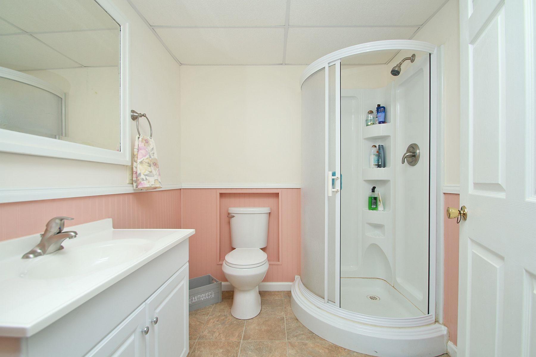 392 Morgans Fork Road Penhook, VA 24137 - Photo 18 of 56 a bathroom with a granite countertop sink toilet and shower