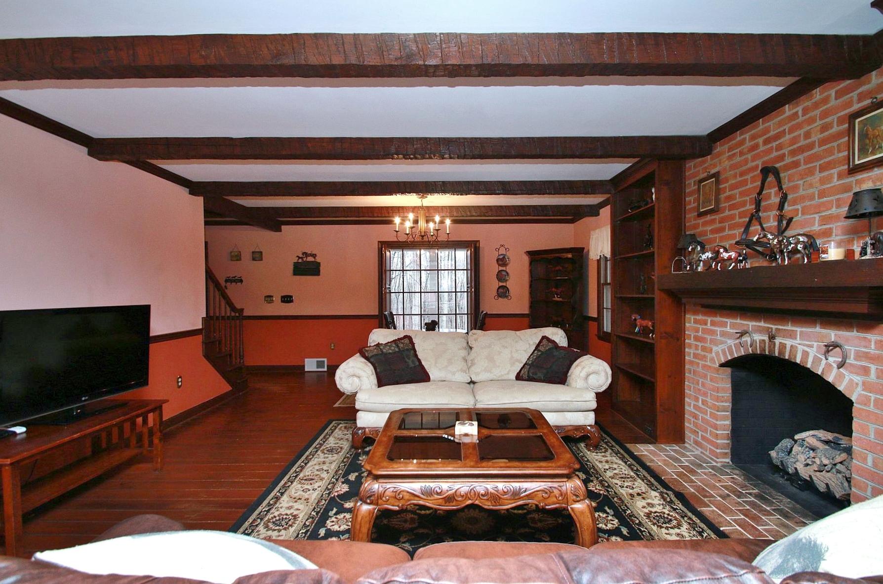 392 Morgans Fork Road Penhook, VA 24137 - Photo 3 of 56 a living room with furniture a flat screen tv and a fireplace
