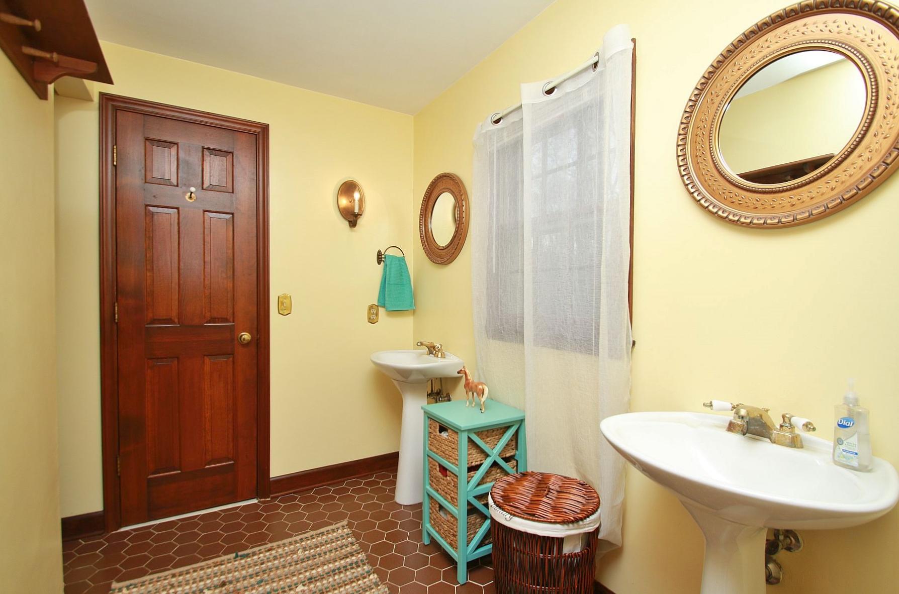 392 Morgans Fork Road Penhook, VA 24137 - Photo 24 of 56 a bathroom with a sink a mirror a toilet and a mirror