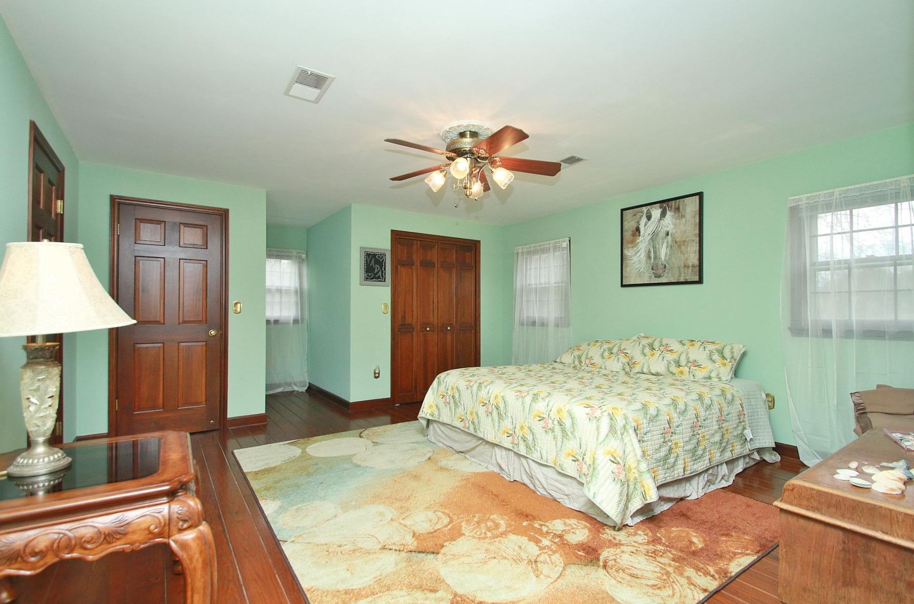 392 Morgans Fork Road Penhook, VA 24137 - Photo 26 of 56 a bedroom with a bed and a chandelier