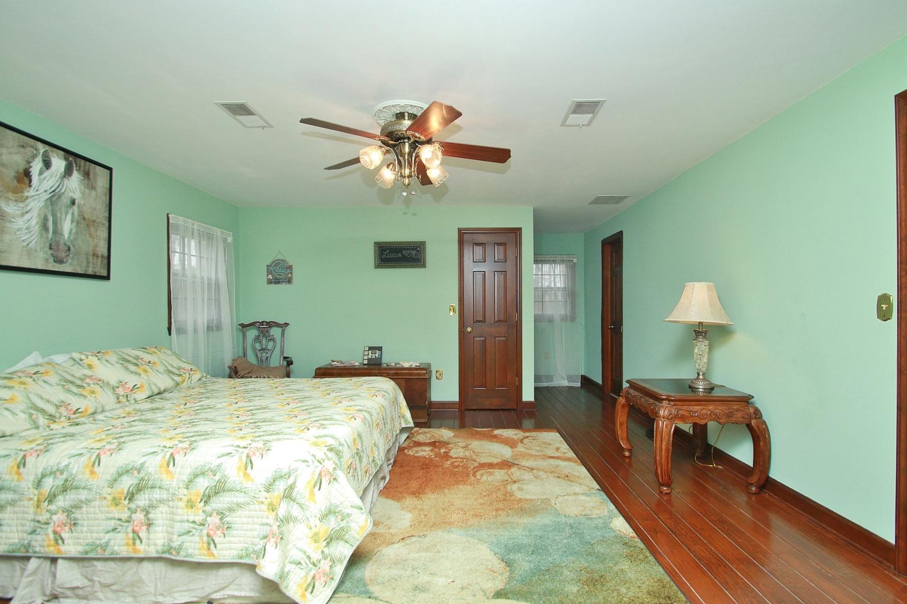 392 Morgans Fork Road Penhook, VA 24137 - Photo 27 of 56 a bedroom with a bed and a chandelier